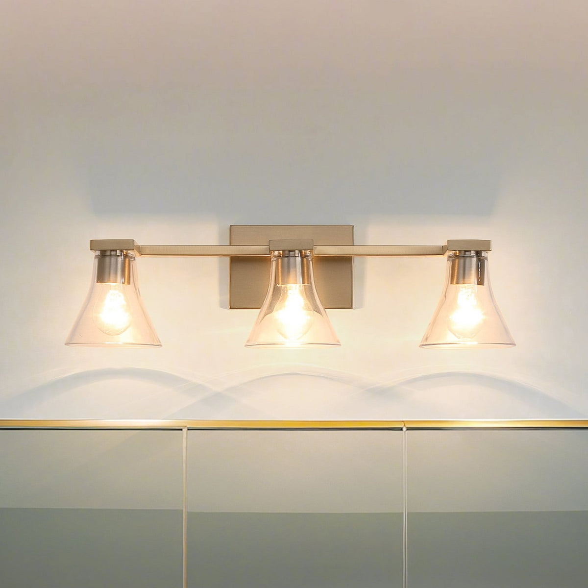 Thesis Gilford bathroom wall lamp, 3-bulb, 24 in, gold-coloured